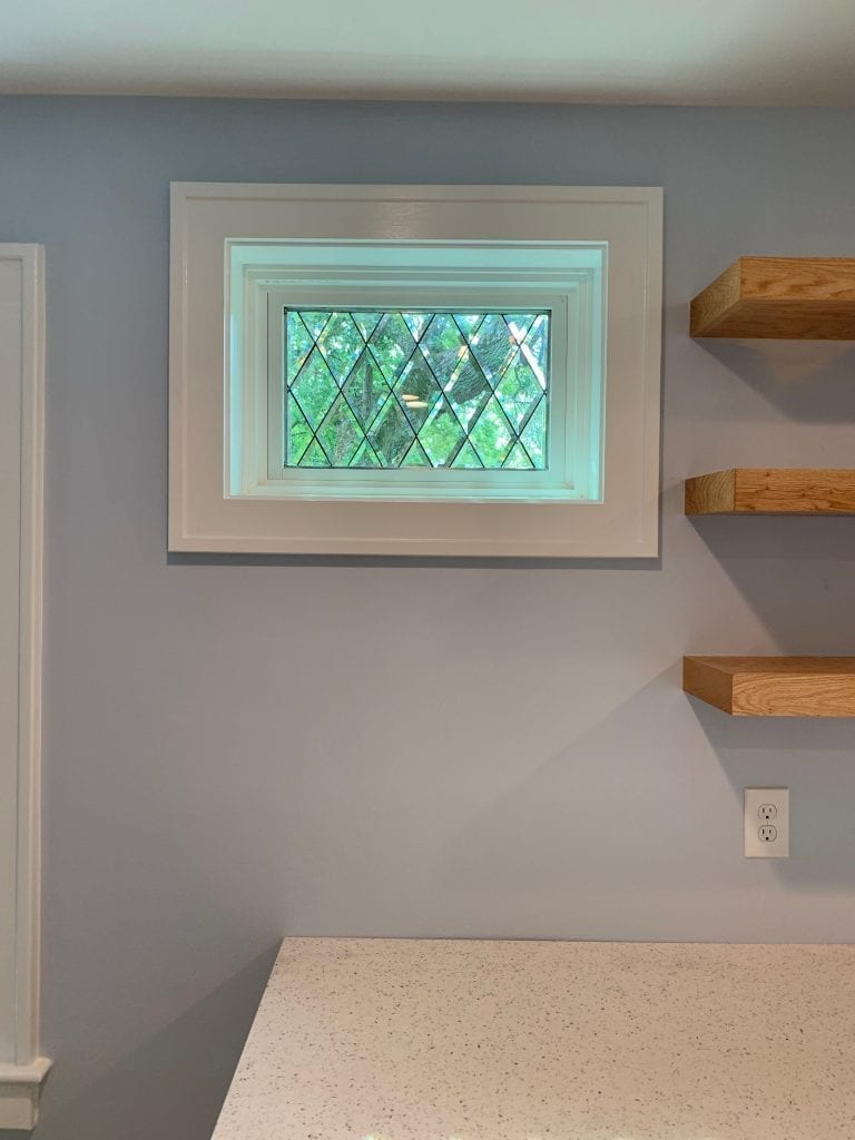 Tudor Style Beveled Diamonds Windows Used In A Kitchen Area